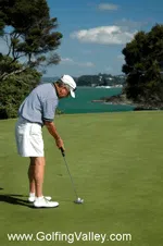 A senior golfer attempting a putt